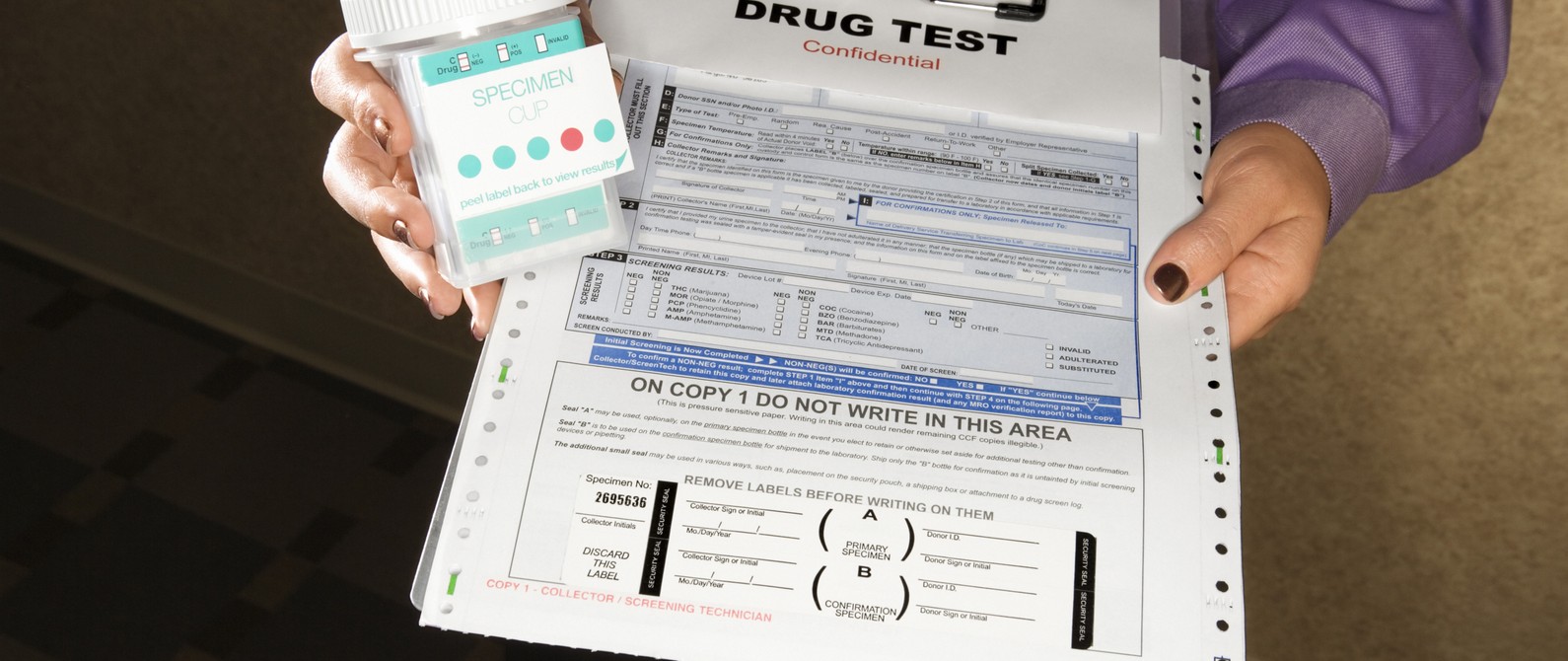 Woman holding clipboard with drug test